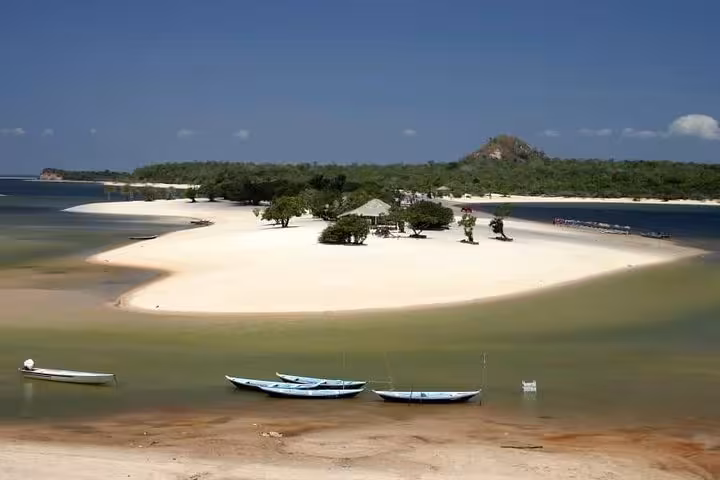 White sand island in Alter do Chao with boats on Tapajos River, Amazon lagoon scenery on guided tour