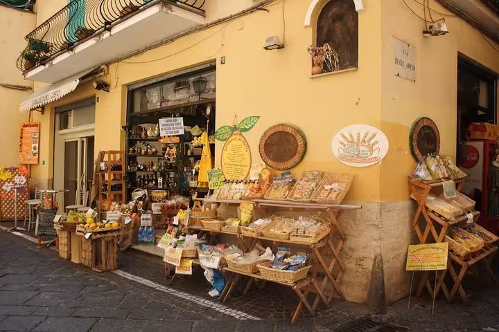 Charming Italian shopfront displaying local goods in a quaint Amalfi Coast village, perfect for cultural immersion.
