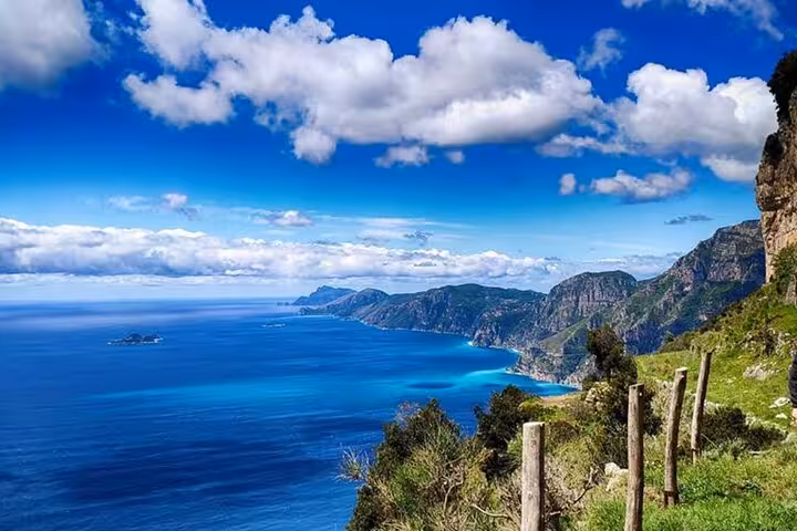 Breathtaking view of the Amalfi Coast from the Path of the Gods, showcasing azure waters and rugged cliffs.