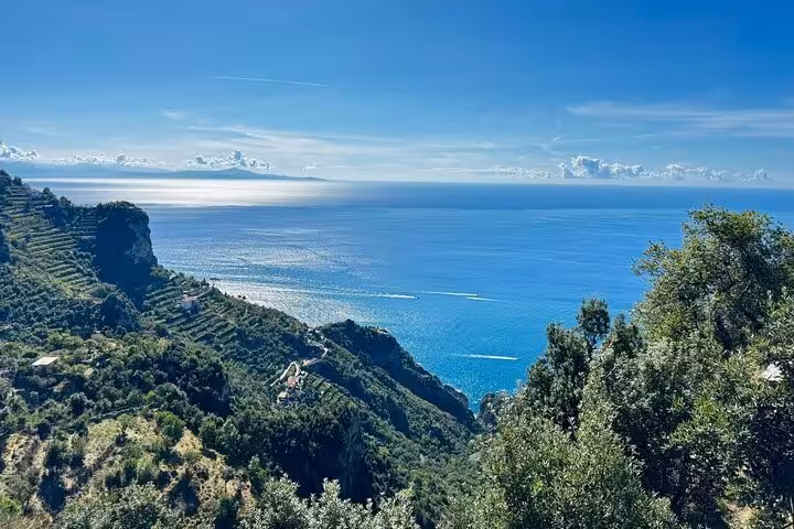 Breathtaking view of the Amalfi Coast's azure sea and lush cliffs from the scenic Path of the Gods trek.