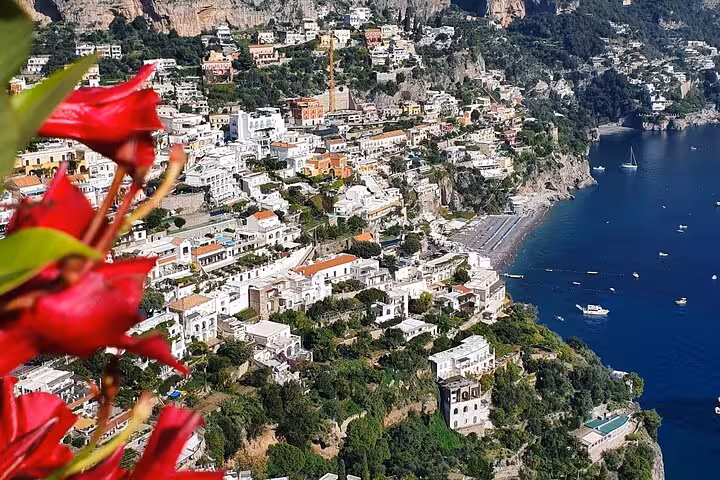 Stunning aerial view of Amalfi Coast's Positano with colorful flowers, ideal for a scenic private tour from Sorrento.