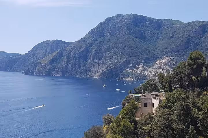 Amalfi Coast cliffs and hillside villages above blue sea, scenic stop on Ravello Amalfi Positano tour from Rome
