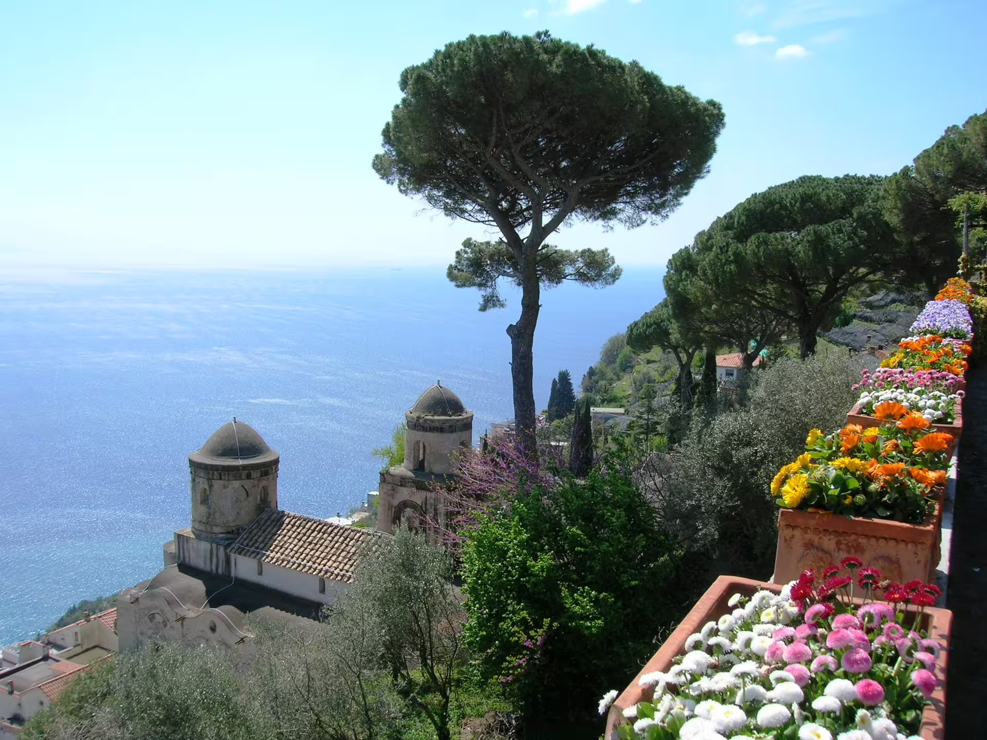 Panoramic view from Villa Rufolo in Ravello with sea, pine trees and flowered terrace on an Amalfi Coast day trip from Salerno