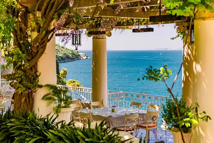 Romantic terrace restaurant overlooking Amalfi Coast bay with sea views, ideal stop on a private Amalfi Town tour