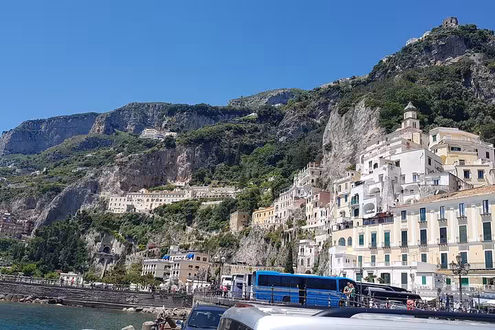 Amalfi town waterfront and cliffside buildings seen on a Rome day tour of the Amalfi Coast and Ravello