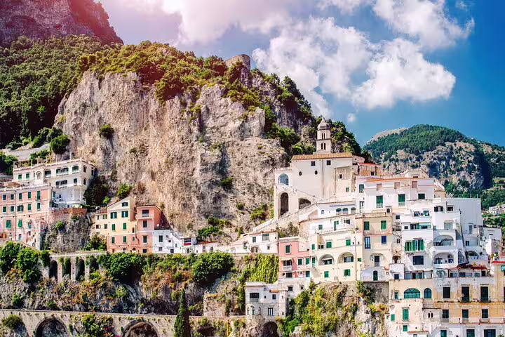 Cliffside houses and church overlooking the sea in Amalfi town, showcasing iconic coastal scenery on a personalized tour