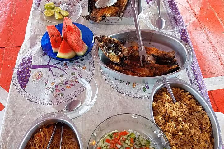 Traditional Amazon boat lunch from Manaus with fried fish, rice, salad and watermelon on river tour