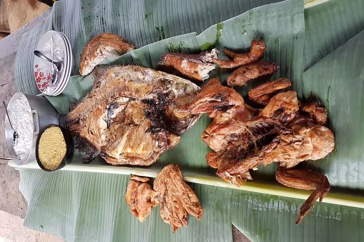 Traditional Amazon meal served on banana leaves during Tucandeira ants indigenous ritual village visit