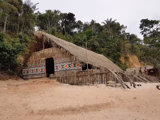 Traditional Amazon jungle village hut on riverbank, cultural stop on 3-day Amazon Jungle Adventure Tour