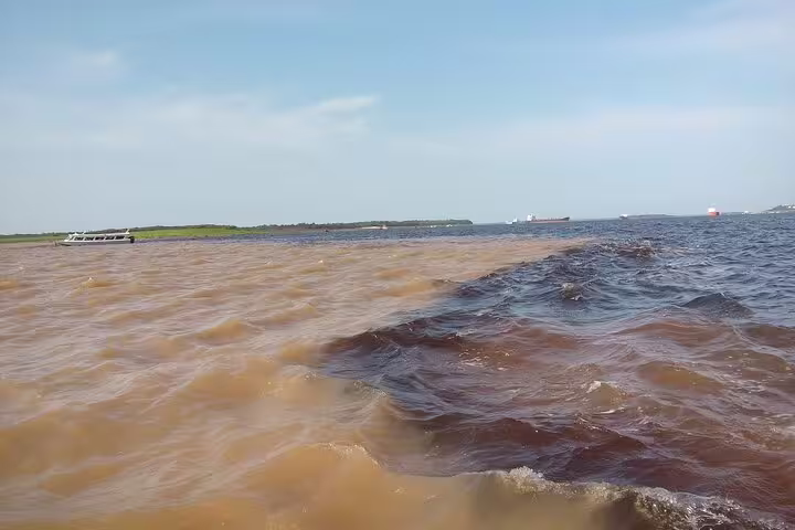 View of the unique Meeting of Waters phenomenon in the Amazon, where two rivers' contrasting colors converge.