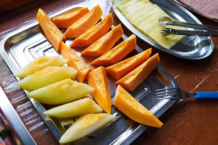 A tray of fresh papaya and melon slices at Amazon Mamori Lodge, showcasing delicious Amazonian breakfast options.