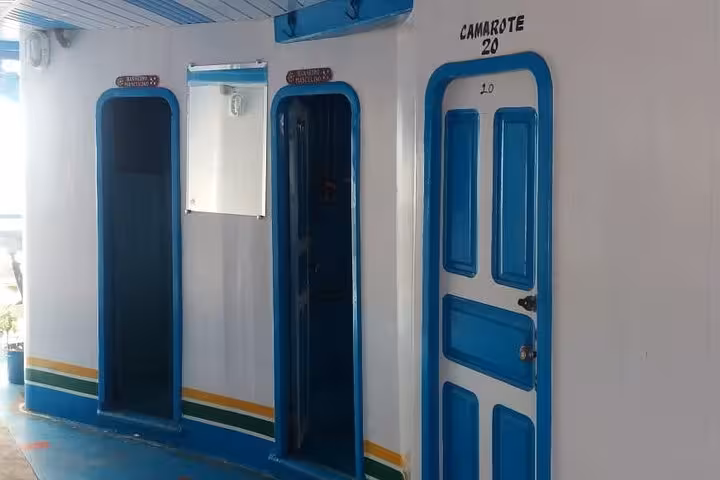 Cabin corridor with numbered doors on Amazon River boat, overnight comfort on 6-day Manaus to Tabatinga tour