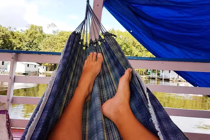 Relaxing in a hammock on an Amazon River boat from Manaus, cruising past riverside jungle homes