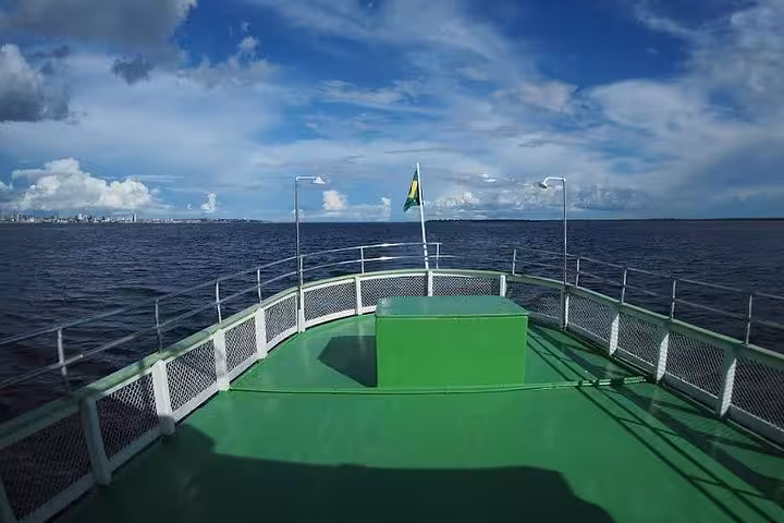 Bow deck view on Amazon riverboat from Manaus to Tabatinga, private cabin cruise under blue skies