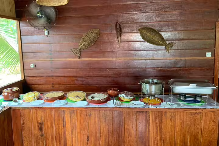 Buffet spread of traditional Amazonian cuisine at Mamori Lodge, showcasing authentic flavors in a rustic dining area.