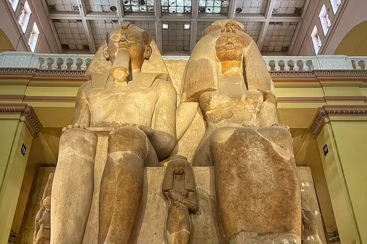 Close-up of the colossal statues of Amenhotep III and Tiye at the Egyptian Museum on a private tour
