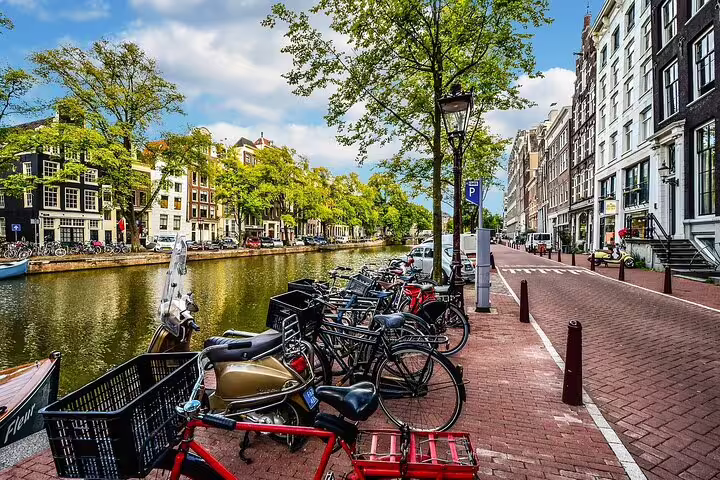 Amsterdam canal with parked bikes, meeting point for a private day trip to Utrecht with local guide