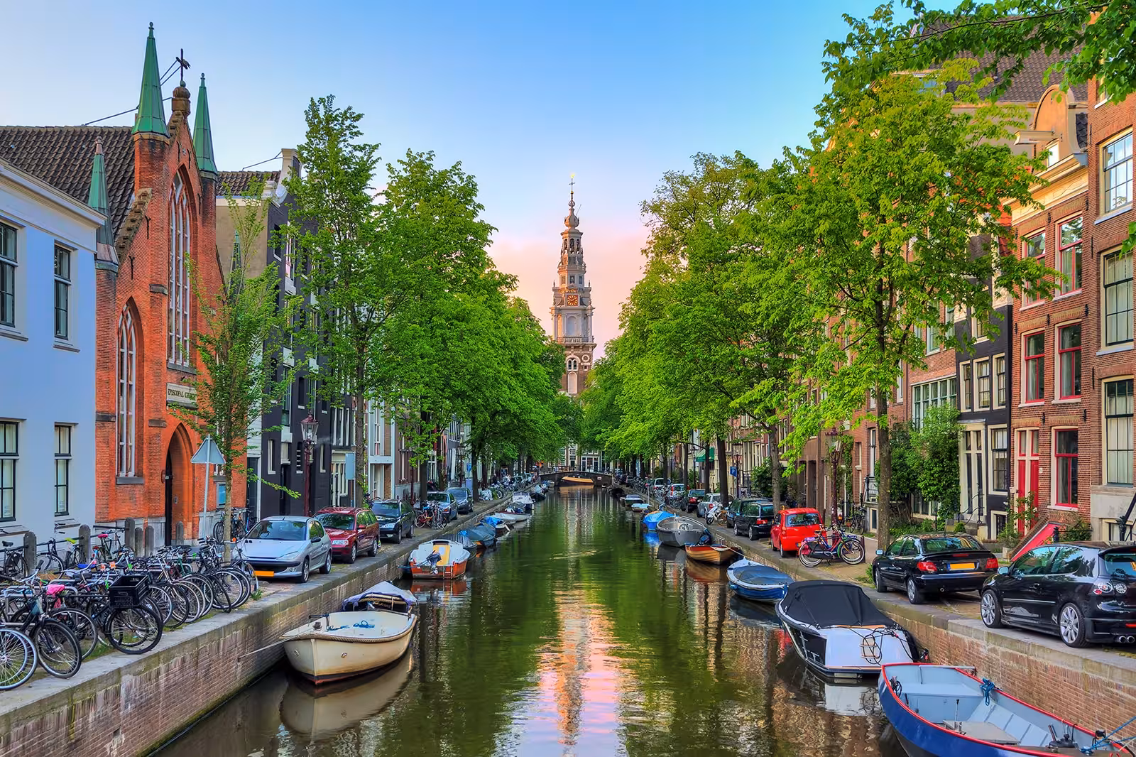 Amsterdam canal with boats and historic houses, ideal stop on private Rotterdam to Kinderdijk and Amsterdam tour