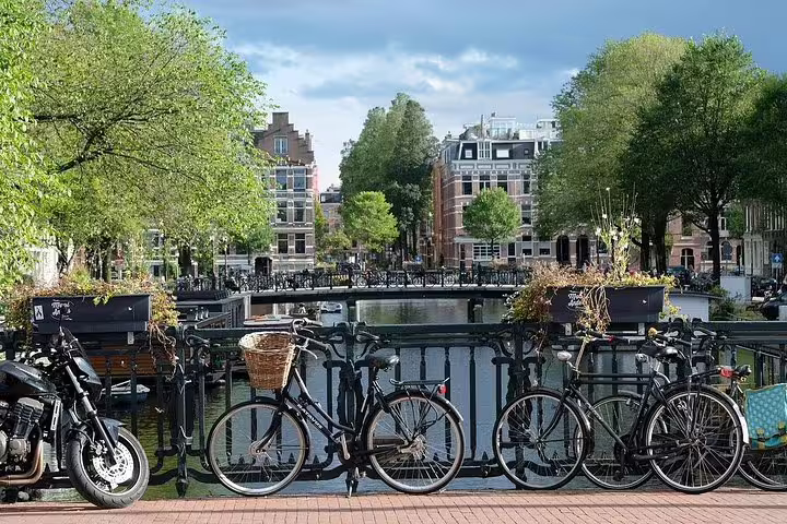 Bicycles on an Amsterdam canal bridge, classic city view on a private half-day sightseeing tour