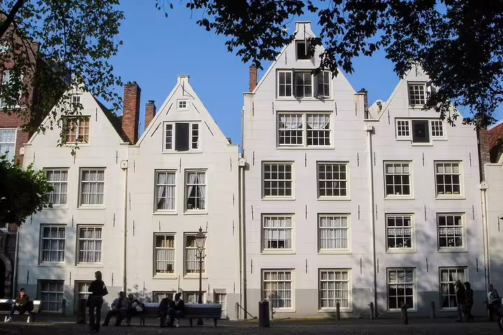 White gabled canal houses in Amsterdam, classic architecture featured on a private walking tour of famous painters