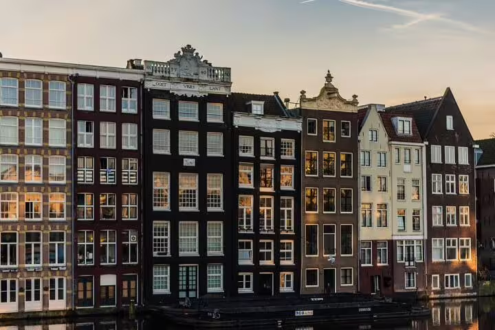 Classic canal houses at sunset in Amsterdam, featured sights on Amsterdam Best with Niki audio GPS walk tour