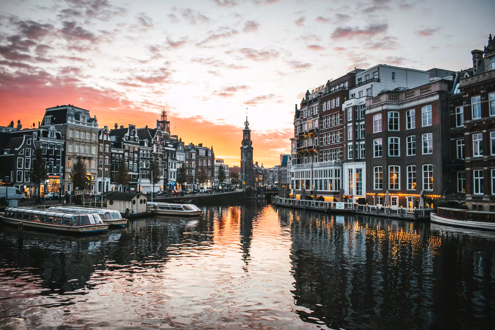 Amsterdam canal sunset with Magere Brug area, ideal stop on a private layover tour from Schiphol
