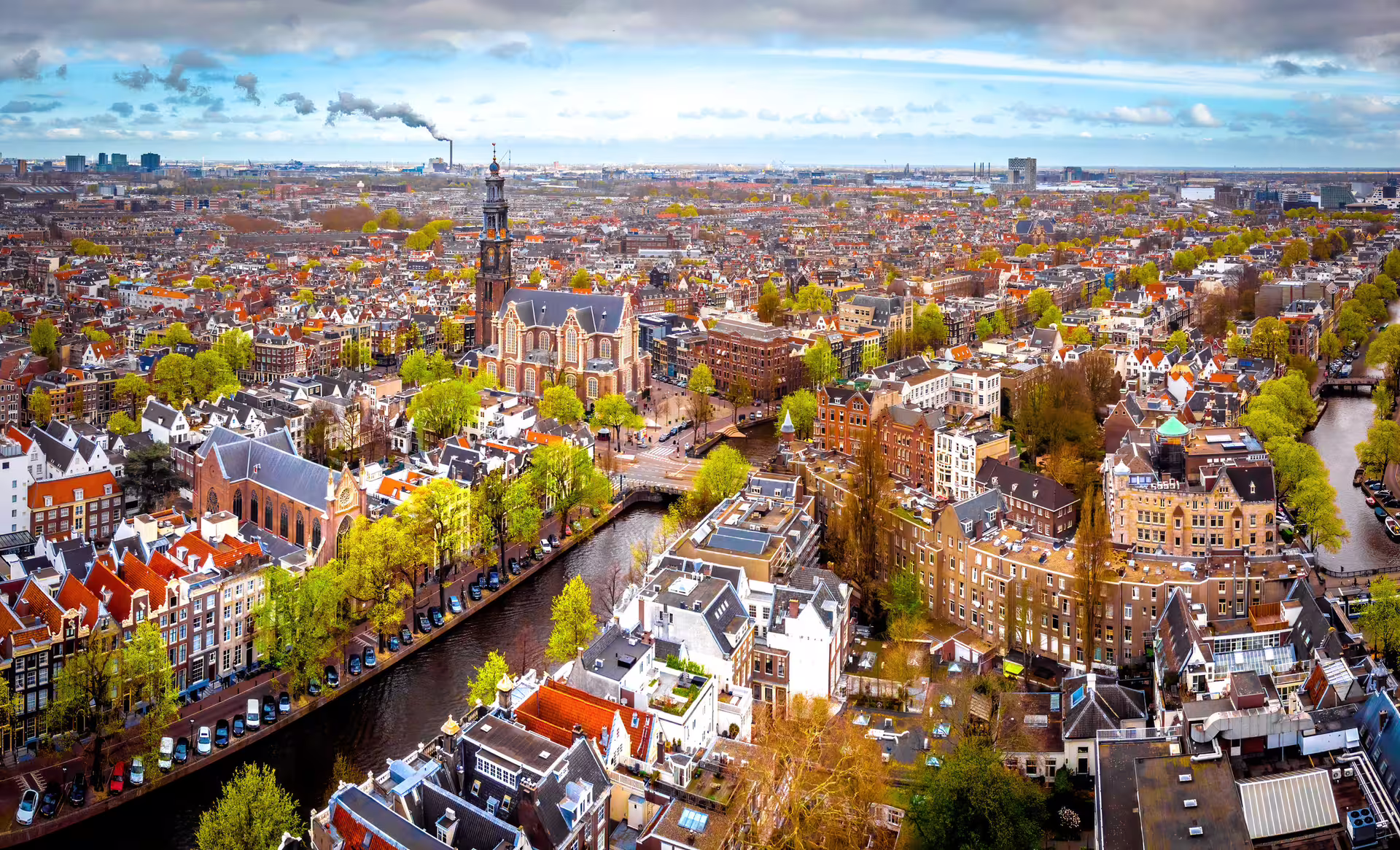 Aerial view of Amsterdam canals and Westerkerk area, key highlights on a 1-day walking tour audioguide