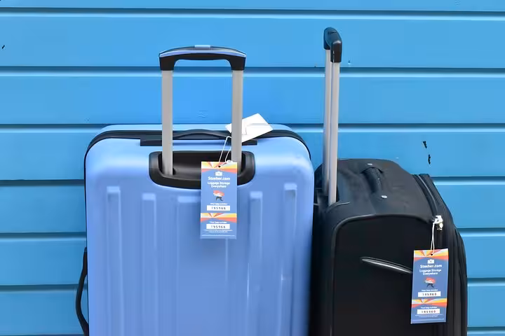 Two suitcases with Stasher tags ready for secure luggage storage near Amsterdam Central Station, hands-free travel