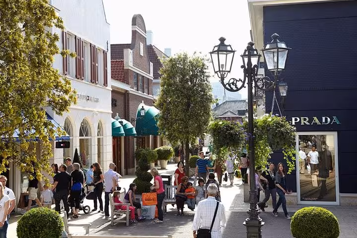 Tree-lined lane with Prada store at Designer Outlet Roermond, featured on private Amsterdam to Roermond tour