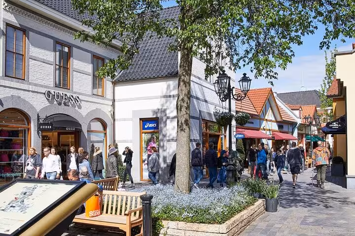 Guess and Asics storefronts at Designer Outlet Roermond, a popular stop on private Amsterdam shopping tour