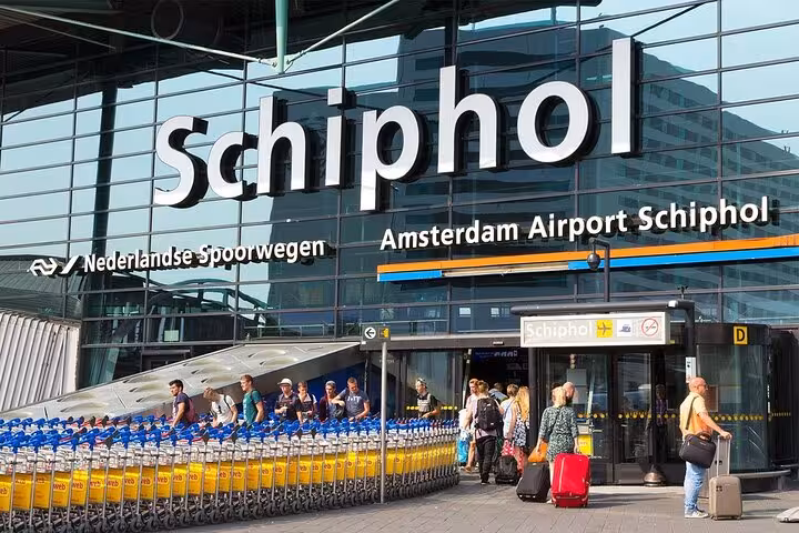 Amsterdam Schiphol Airport arrivals entrance, ideal pickup point for private transfer to Groningen