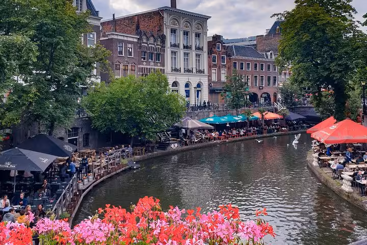 Canal-side cafes and historic buildings in Utrecht, destination for Amsterdam and Schiphol private transfer service