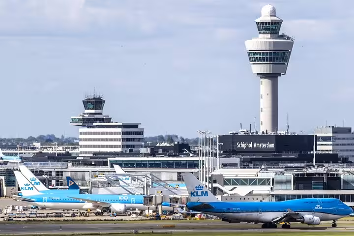 Amsterdam Schiphol Airport terminal and control tower with KLM jets, VIP arrival transfer with meet and greet
