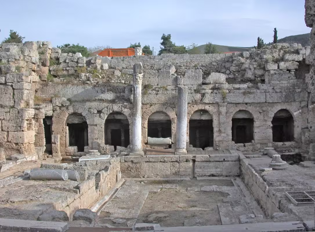 Ancient Corinth archaeological site with stone arches and columns, private tour stop from Athens to Peloponnese