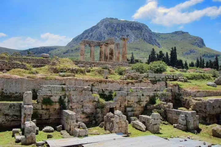 Temple ruins at Ancient Corinth with mountain backdrop, part of a full-day private Corinth tour including lunch