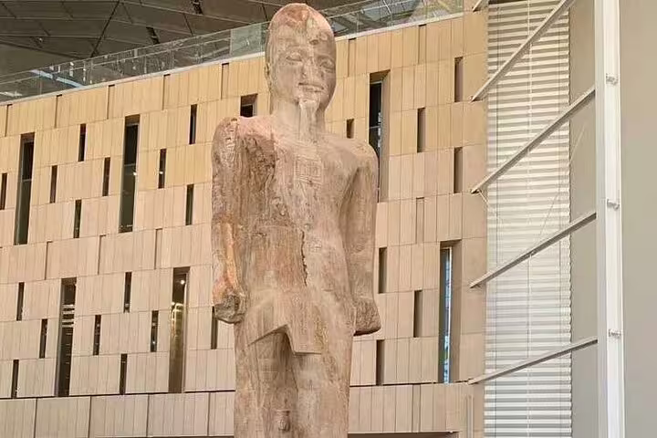 Ancient Egyptian wooden statue displayed at the Grand Egyptian Museum, a key stop on the 3-hour GEM tour