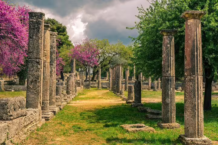 Ancient Olympia archaeological site with stone columns, ideal stop on private transfer from Olympia to Athens