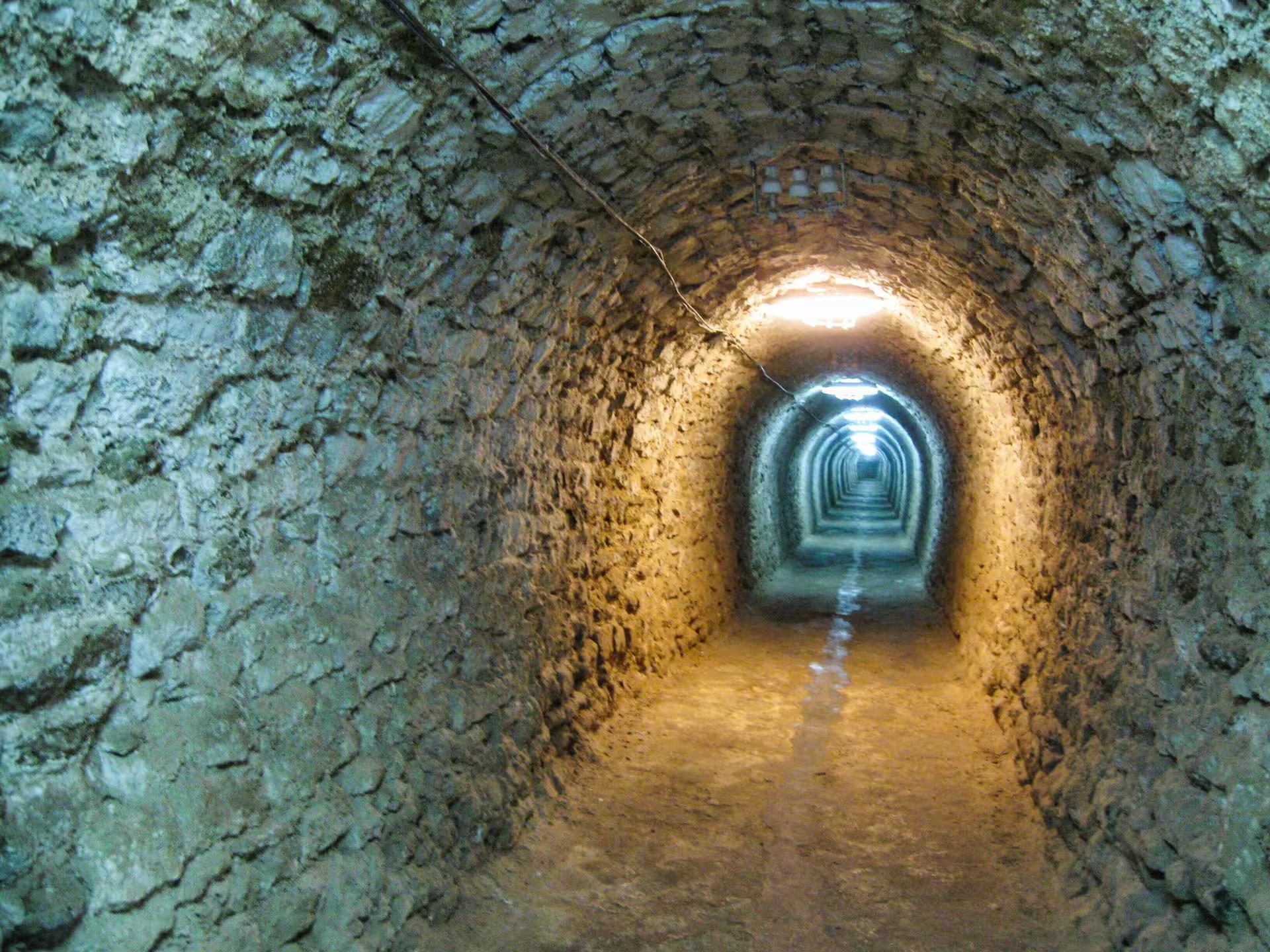 Ancient stone tunnel corridor inside a Transylvania castle explored on a guided castles and Saxon towns tour