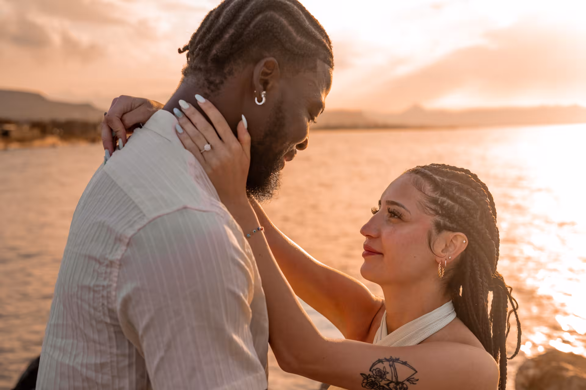 Couple gazing into each other's eyes during a sunset photoshoot at Heraklion Venetian Port.