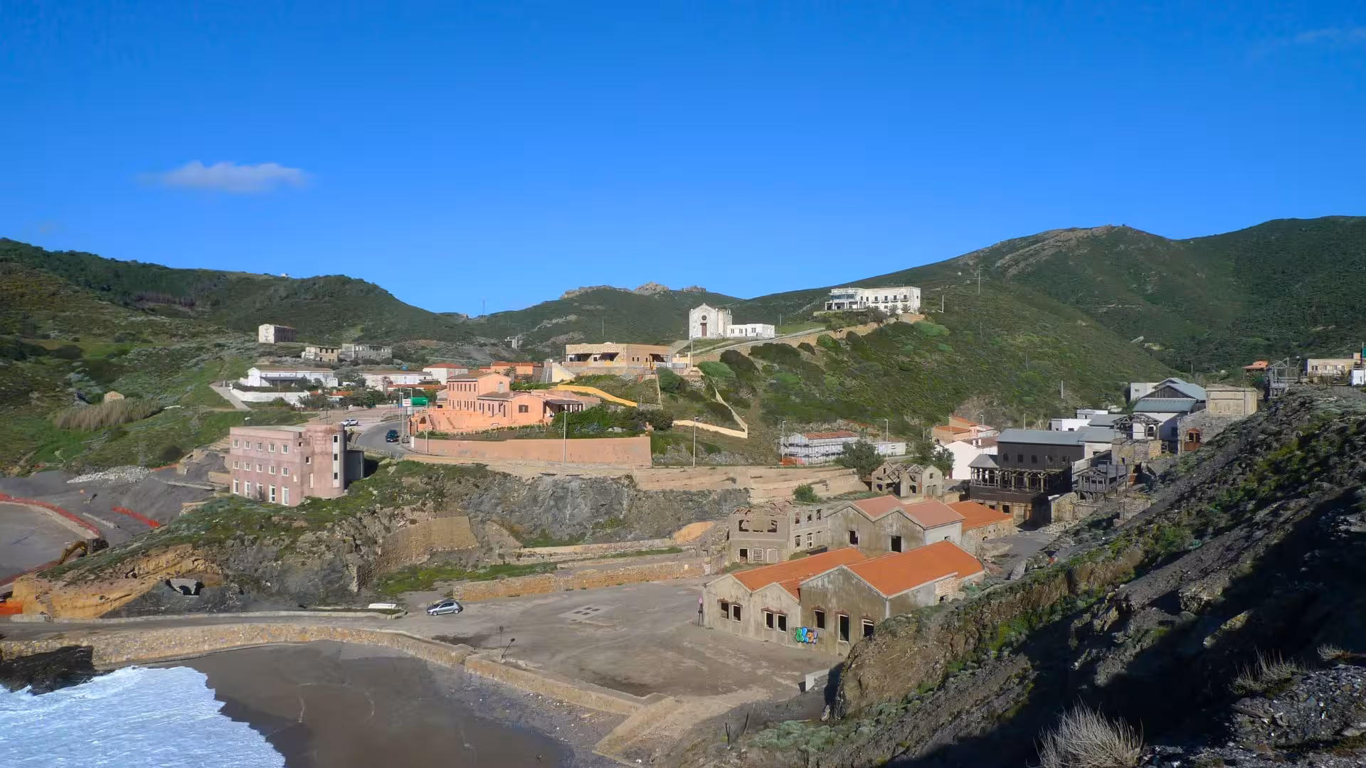 Marvel at the historic charm of Argentiera village surrounded by lush hills, a perfect base for underwater adventures.