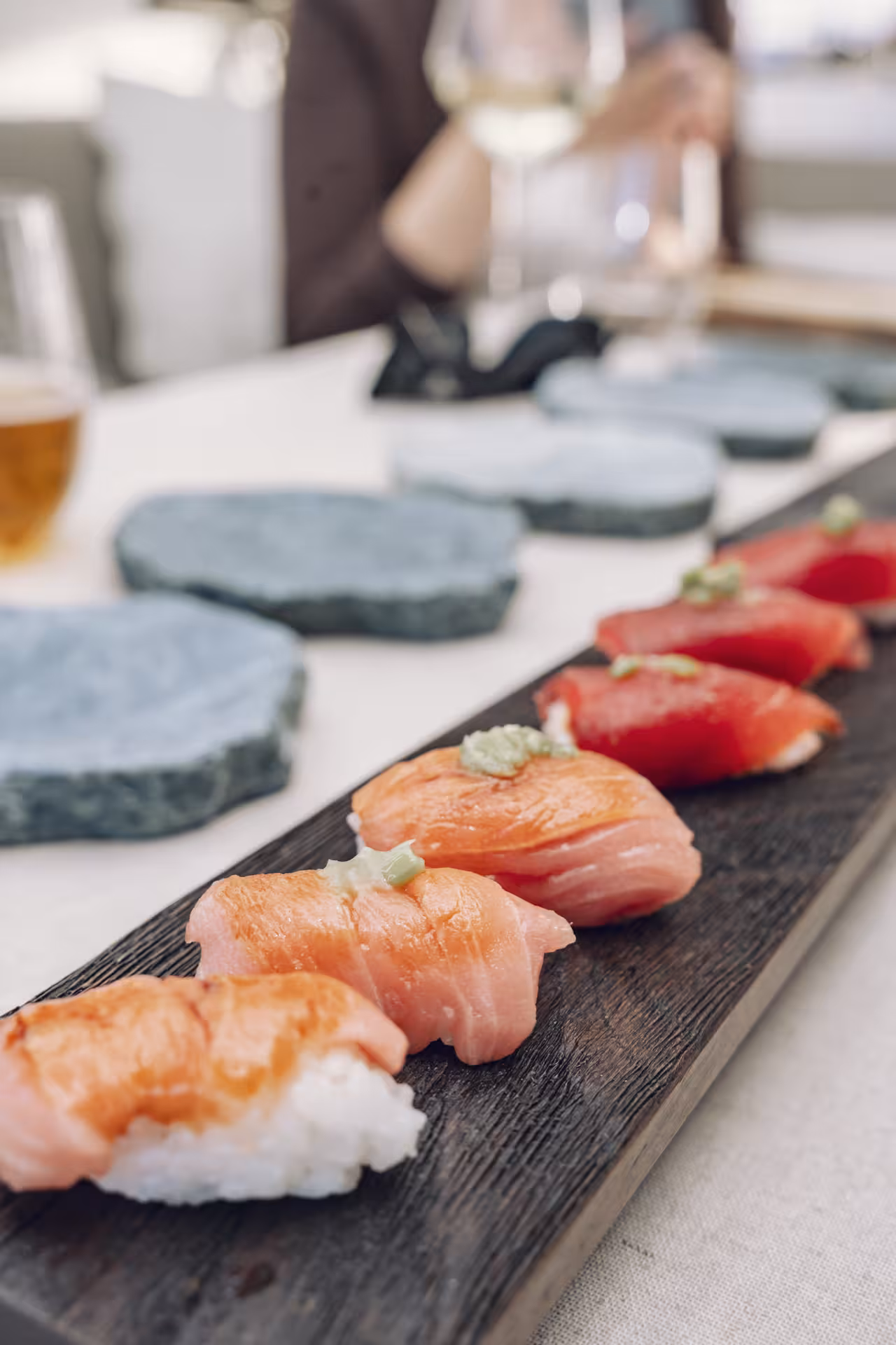 Assorted salmon and tuna nigiri on a wooden board, perfect for a sushi masterclass tasting experience