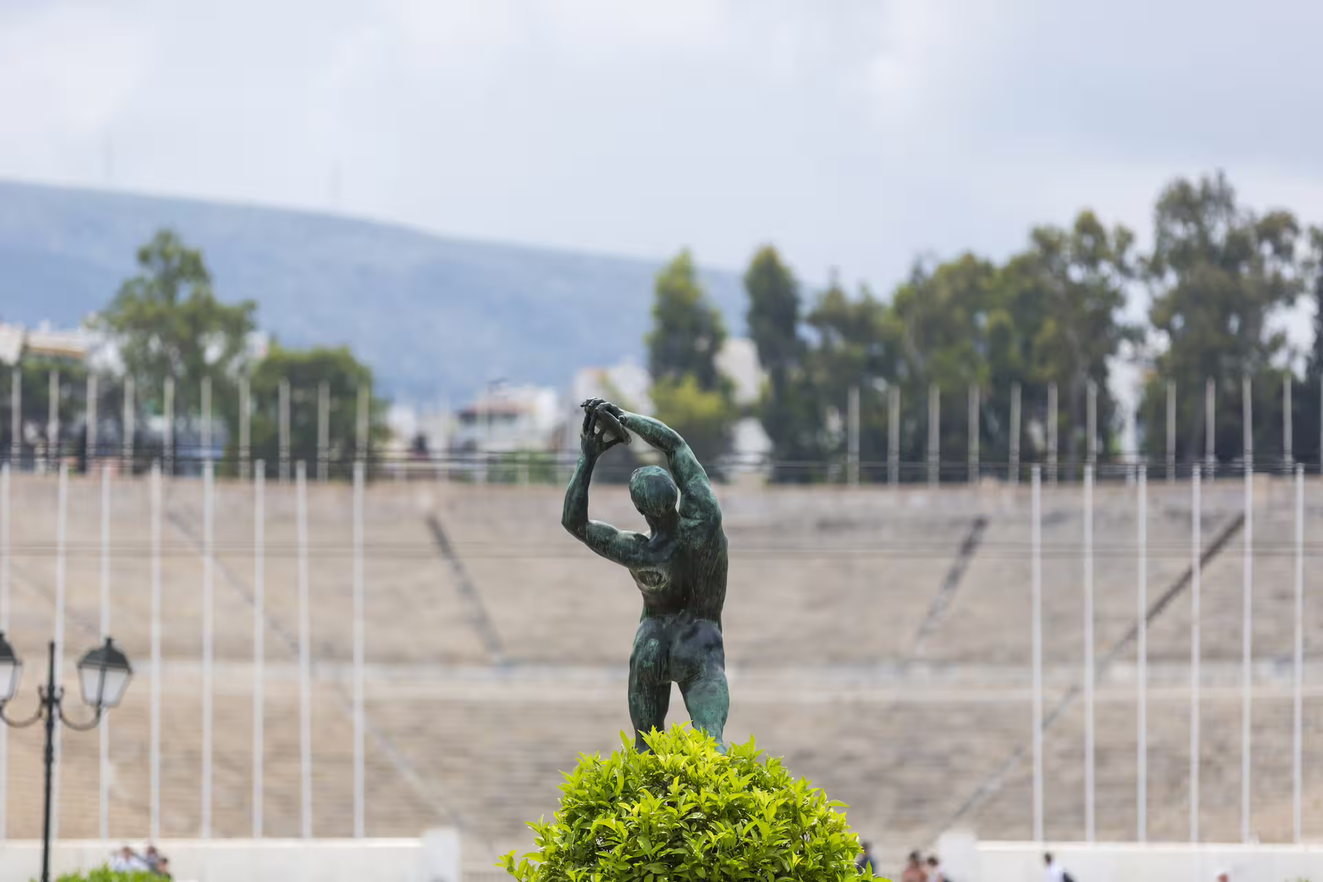 Bronze athlete statue at Panathenaic Stadium area, seen on Athens small-group city tour with Acropolis entry included