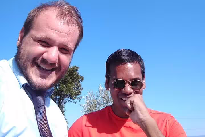 Friendly Athens chauffeur and guest smiling outdoors, premium limousine transfer from Athens city to Acropolis