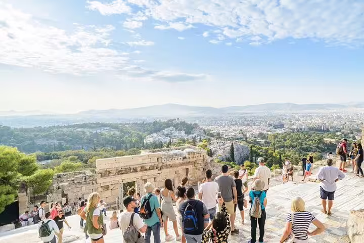 Group on Acropolis hilltop during Athens private walking tour, panoramic city views before Plaka food tastings