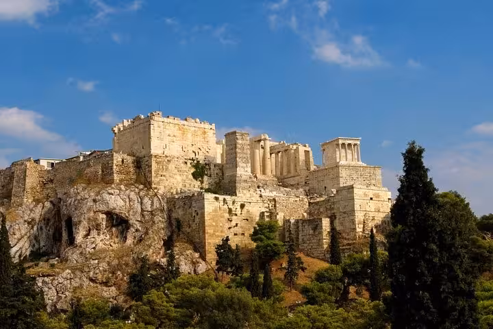 Athens Acropolis hilltop ruins under blue sky, highlight of 7-day Athens Mykonos Santorini tour