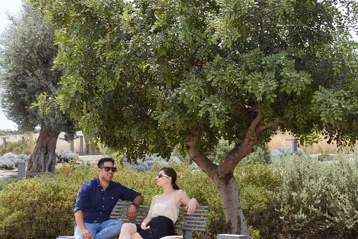 Travelers relaxing in an Athens park during private airport arrival welcome and 1-hour city orientation tour