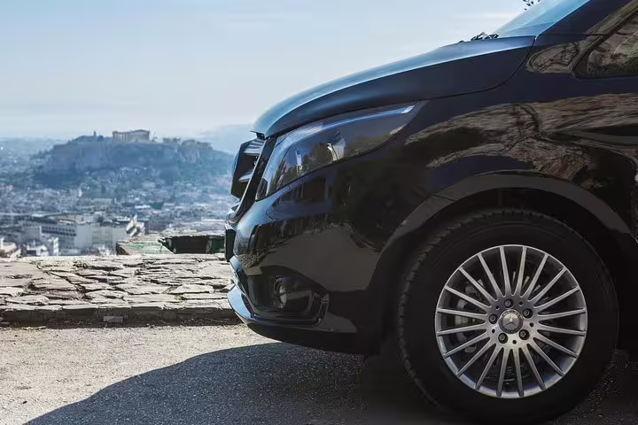 Close-up of private tour vehicle in Athens with Acropolis view, luxury transfer for Cape Sounio day tour