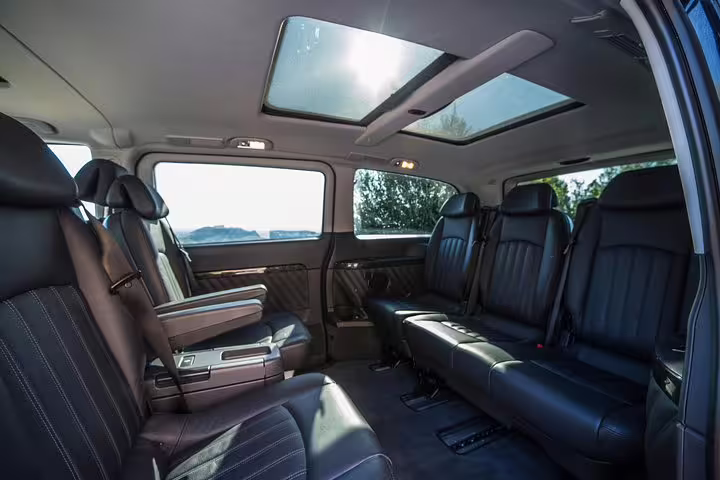 Spacious leather interior of private Athens tour van, premium seating for Best of Athens and Cape Sounio tour