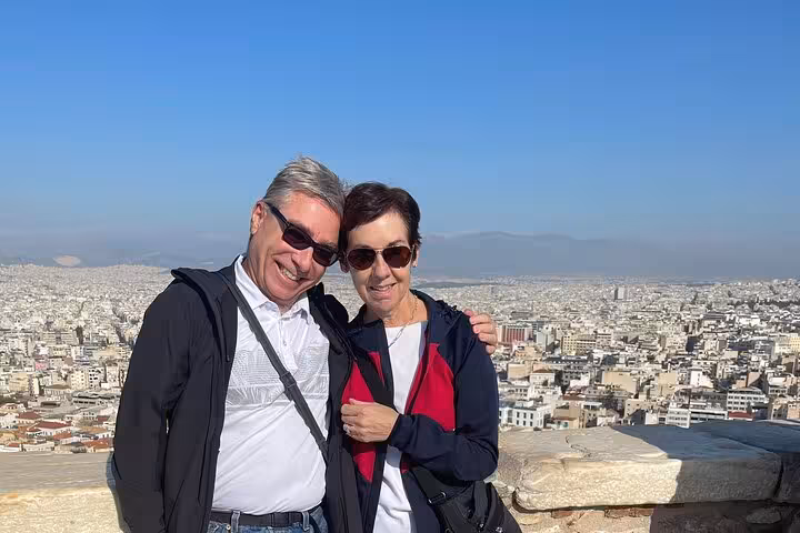 Couple admiring panoramic views of Athens city from a scenic viewpoint on a private shore excursion tour.