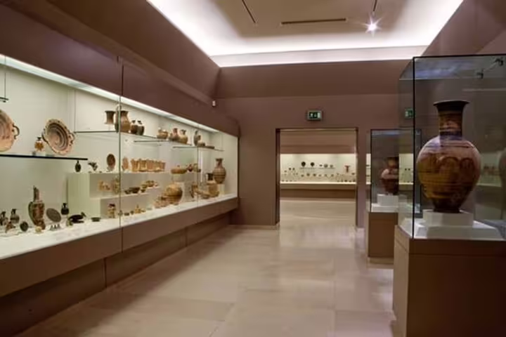 Museum gallery with ancient Greek pottery exhibits, a cultural stop on the Athens to Marathon half-day trip